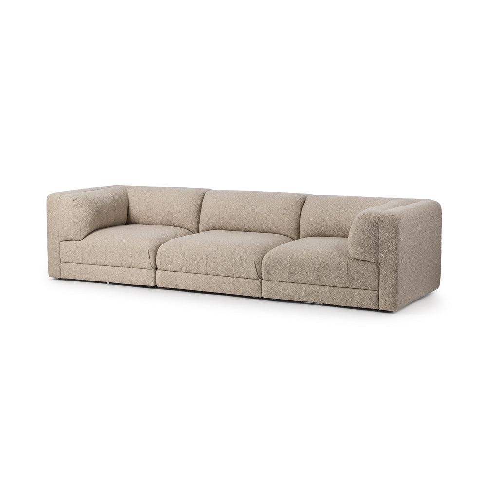 Angled front view of beige three-piece modular sofa with broad cushions and square track arms
