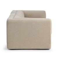 Side view of beige modular sofa showing its wide upholstered arm and low base