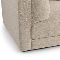 Close-up of beige modular sofa track arm, cushion edges and textured upholstery