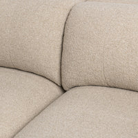 Close-up of beige modular sofa seat and back cushions showing their softly rounded edges