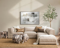 Angled room view of beige modular sectional with an extended seat and sculptural wood coffee table