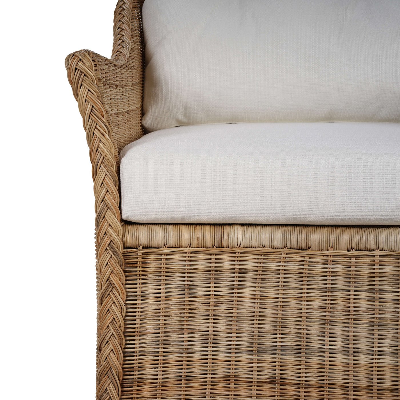 Armrest detail on rattan swivel chair with cushion.