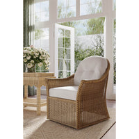 Rattan swivel chair in sunlit room setting.