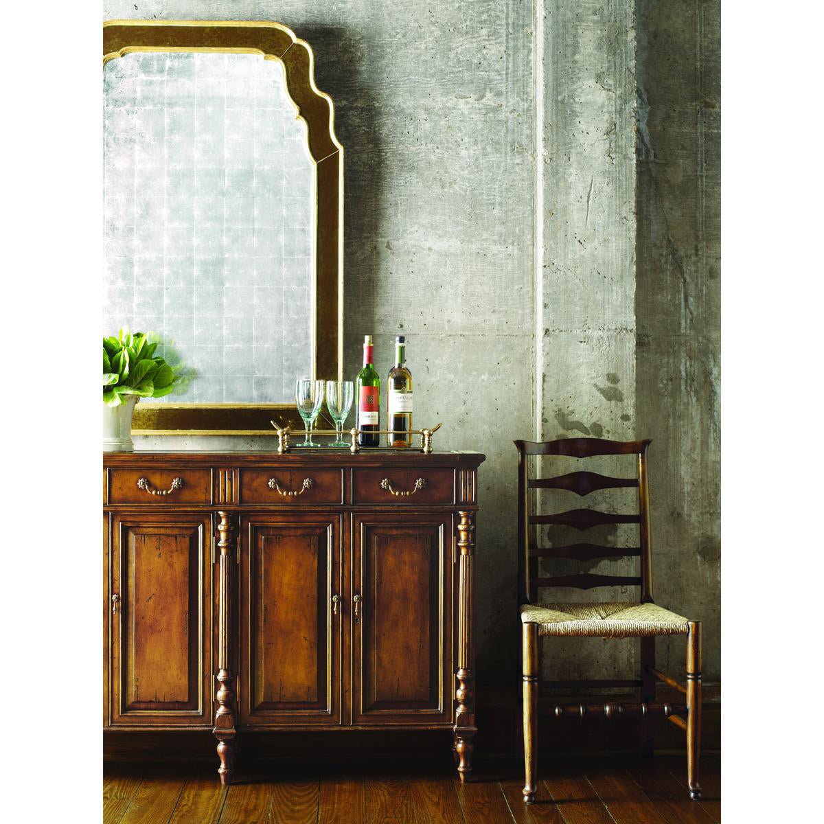 Styled narrow walnut sideboard with chair and accessories.