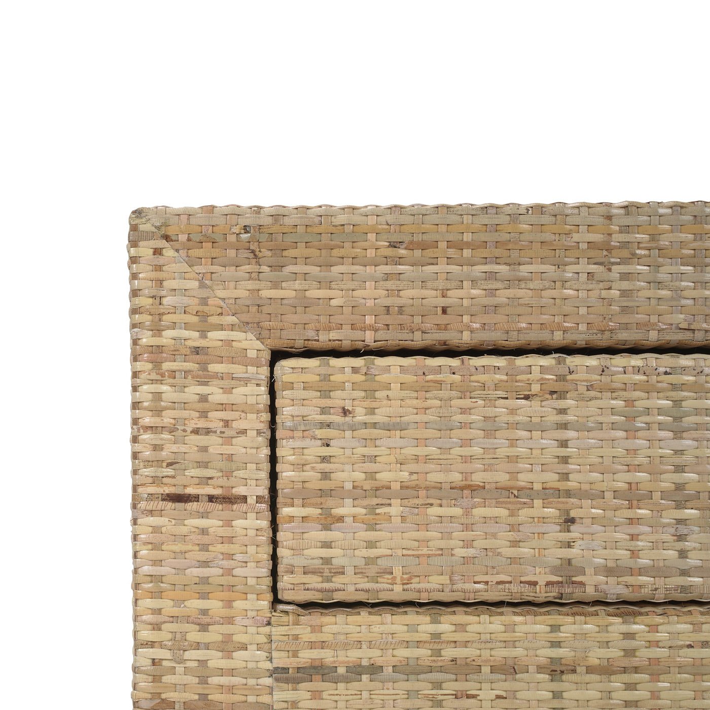 Close-up detail of rattan bedside table corner.