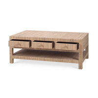 Angled view of natural rattan coffee table, open drawers.