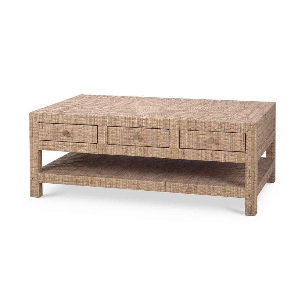 Angled view of natural rattan coffee table with drawers.