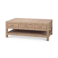 Angled view of natural rattan coffee table with drawers.