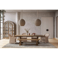Dining setup featuring natural rattan chairs around a table.