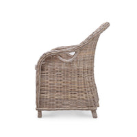 Side profile of natural rattan dining chair.