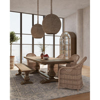 Dining room with rattan chairs and wooden table setup.