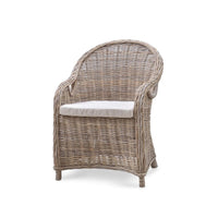Front view of natural rattan dining chair with cushion.