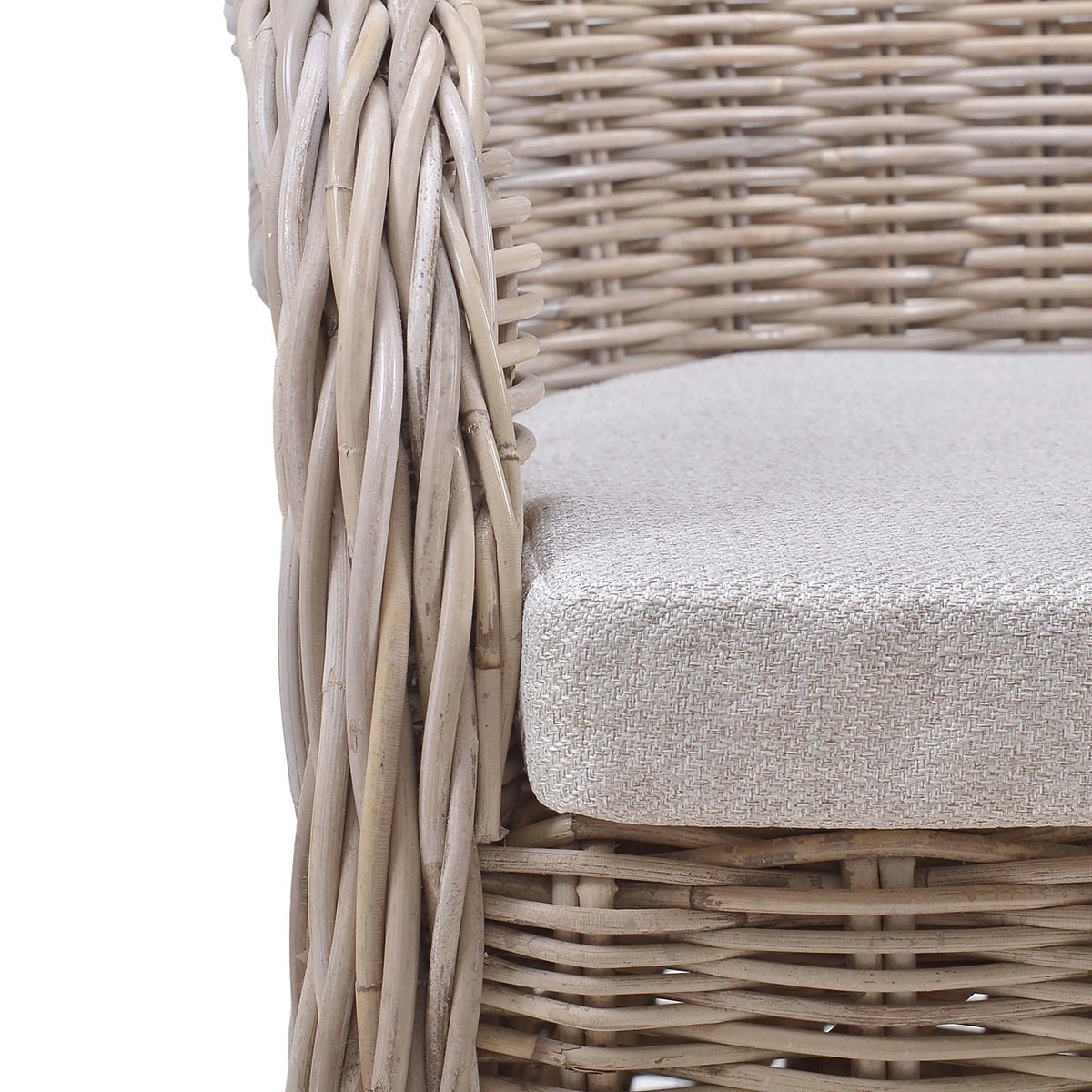 Close-up of chair cushion on natural rattan dining chair.