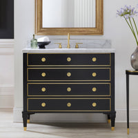 Black vanity with mirror and gold accents in bathroom.