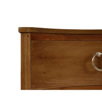 Detail of nightstand's curved edge and handle on drawer.