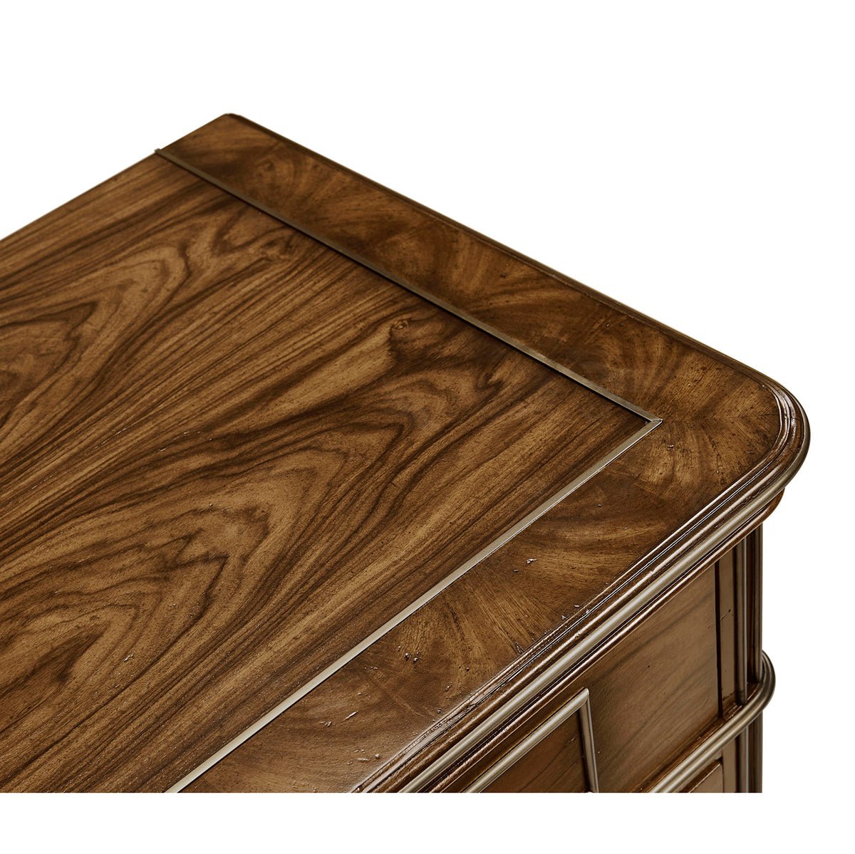 Close-up, top surface of neo classic bedside chest.
