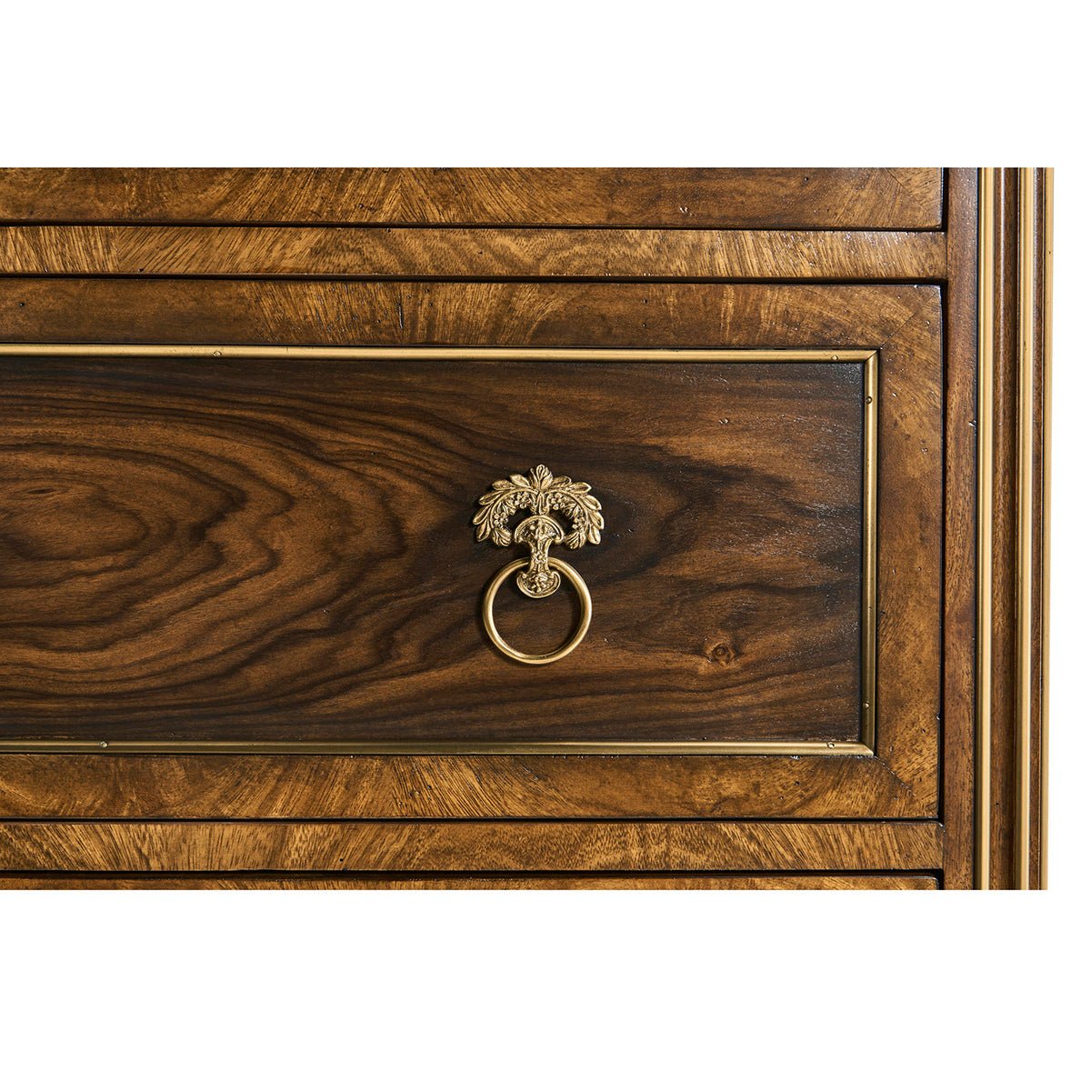 Drawer handle close-up, ornate ring on chest.