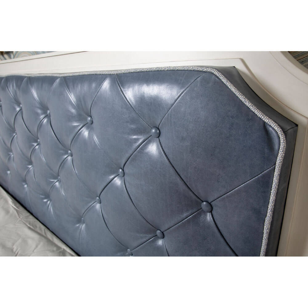 Close-up of tufted blue headboard detail.