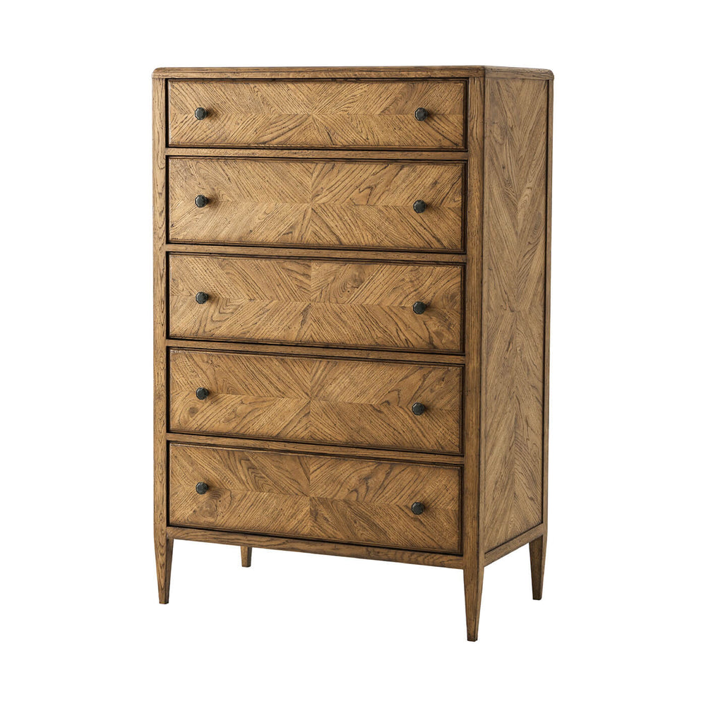 Light oak dresser front angled view, tall five-drawer chest.