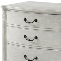 Close-up of nightstand drawer handles, carved corner detail.
