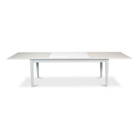 Fully extended white dining table, side perspective.