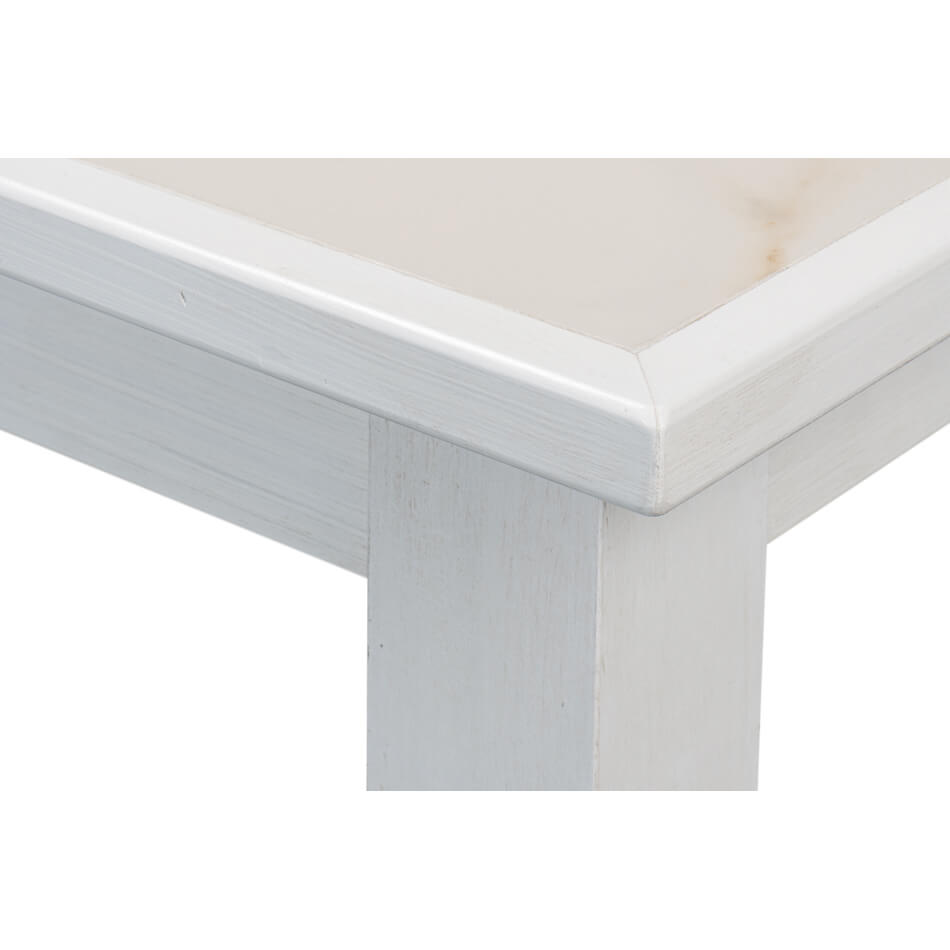 Close-up of white table corner and leg details.