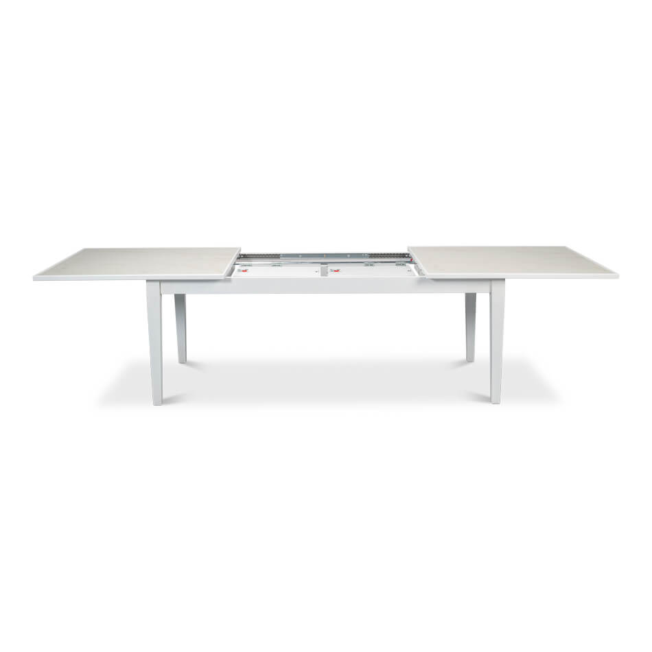 Open white dining table, showing extension mechanism.