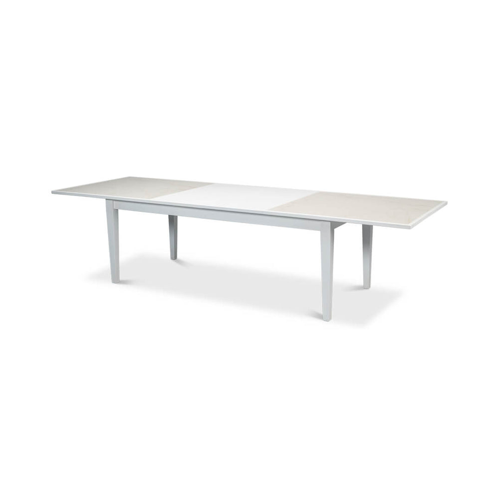 Extended white dining table, full view with inserts.