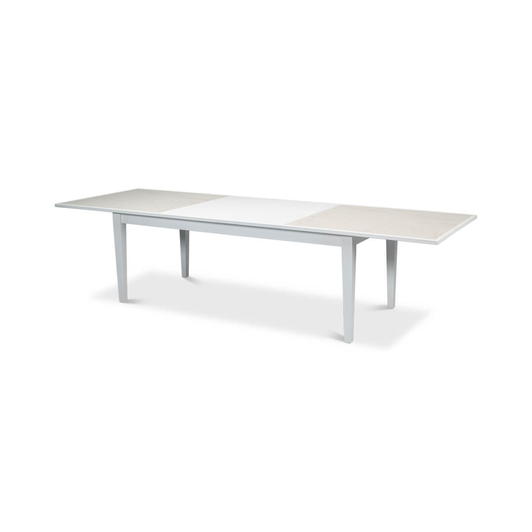 Extended white dining table, full view with inserts.