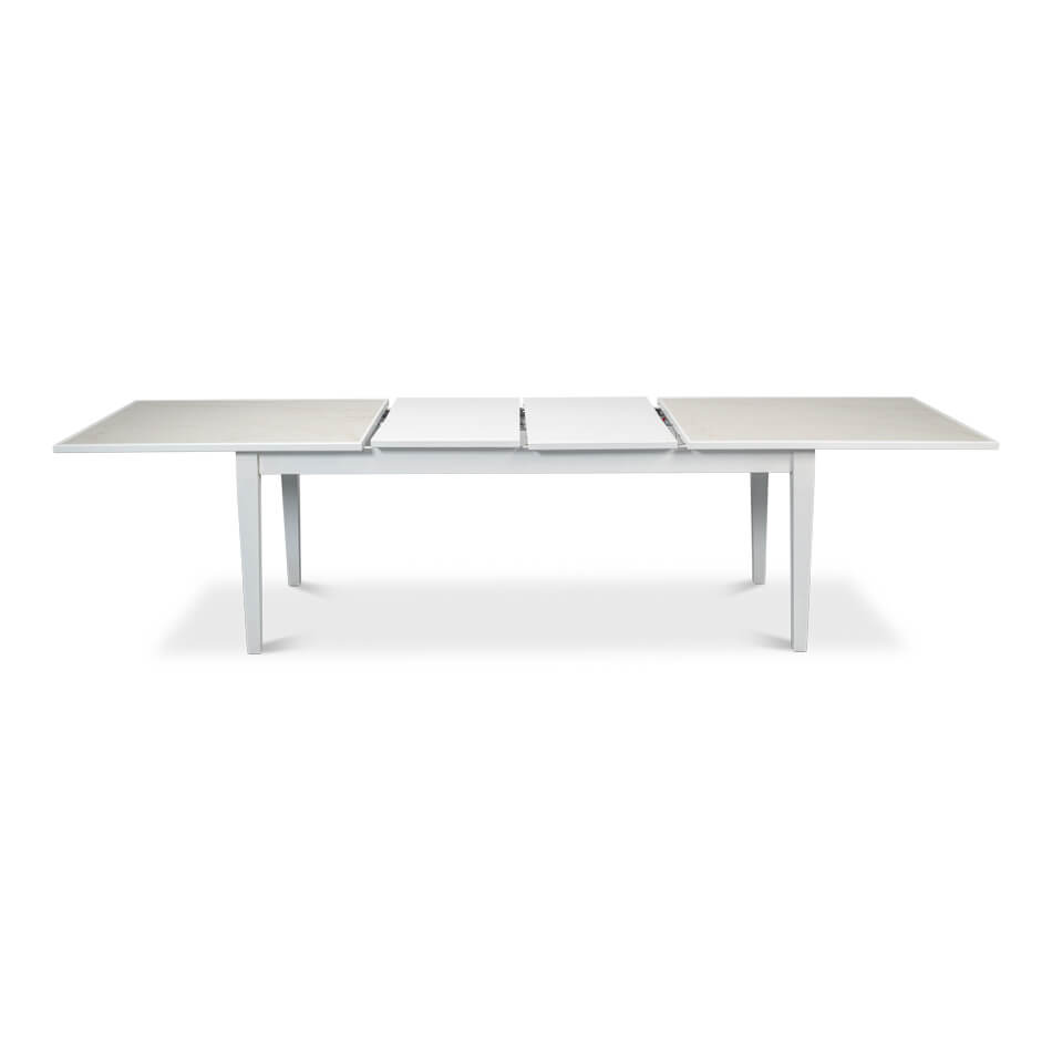 White dining table, partially extended with section visible.