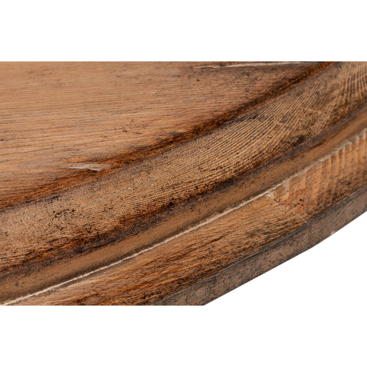 Edge of tabletop, intricate wood detailing visible.