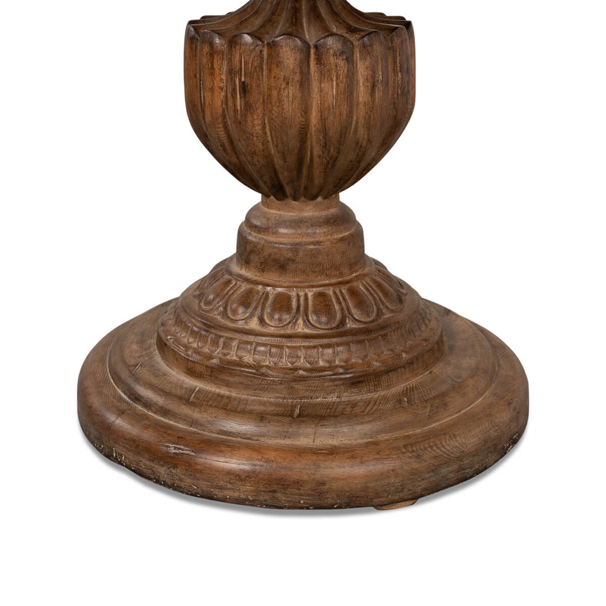 Close-up of ornate table base, decorative carvings.