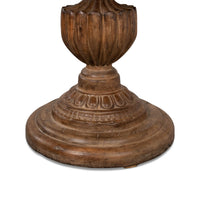 Close-up of ornate table base, decorative carvings.