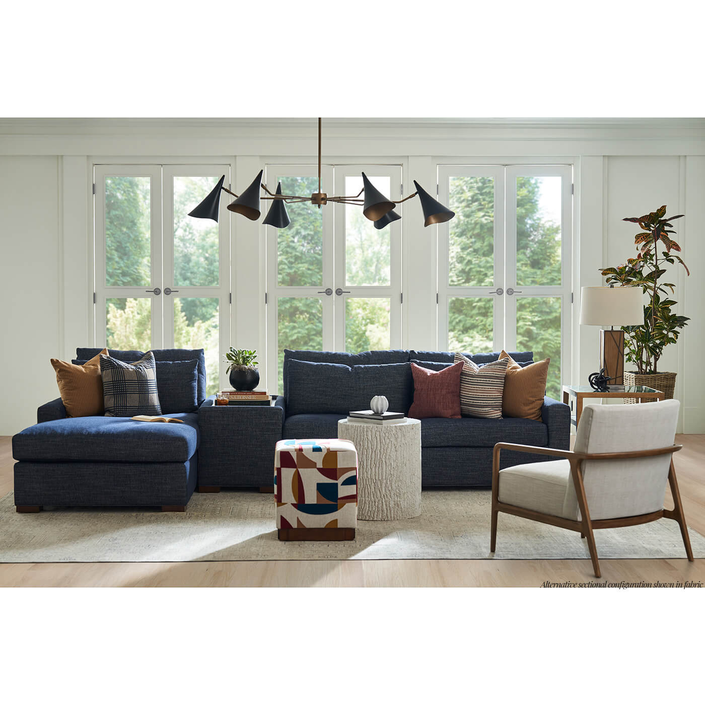 Blue sectional sofa with decor in bright room.