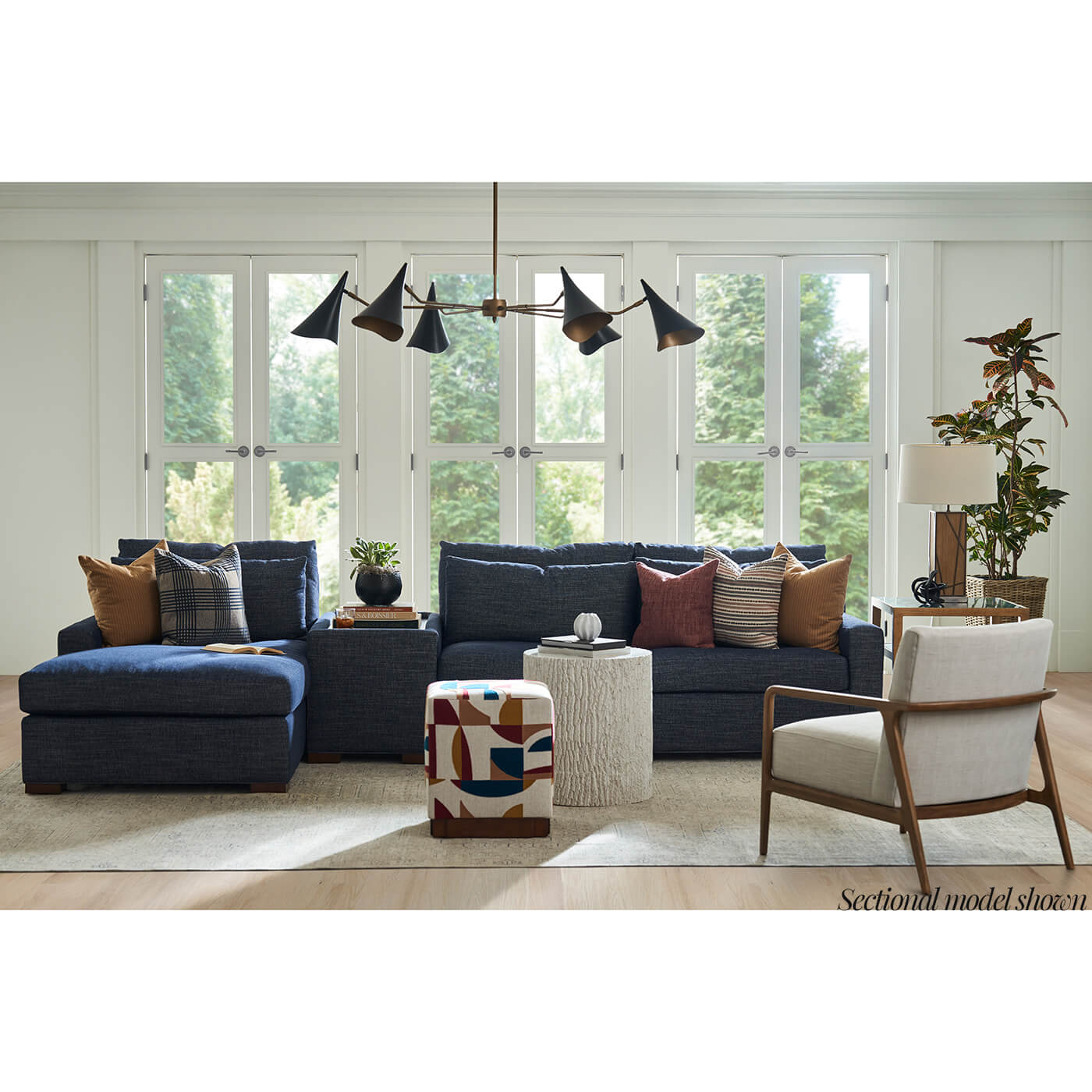 Blue sectional sofa in bright living room scene.