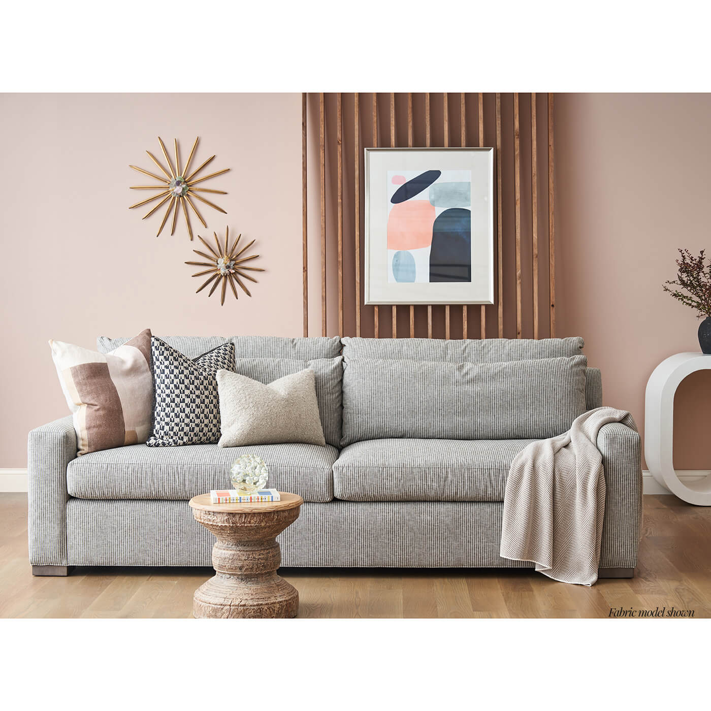 Gray fabric sofa in stylish living room setting.