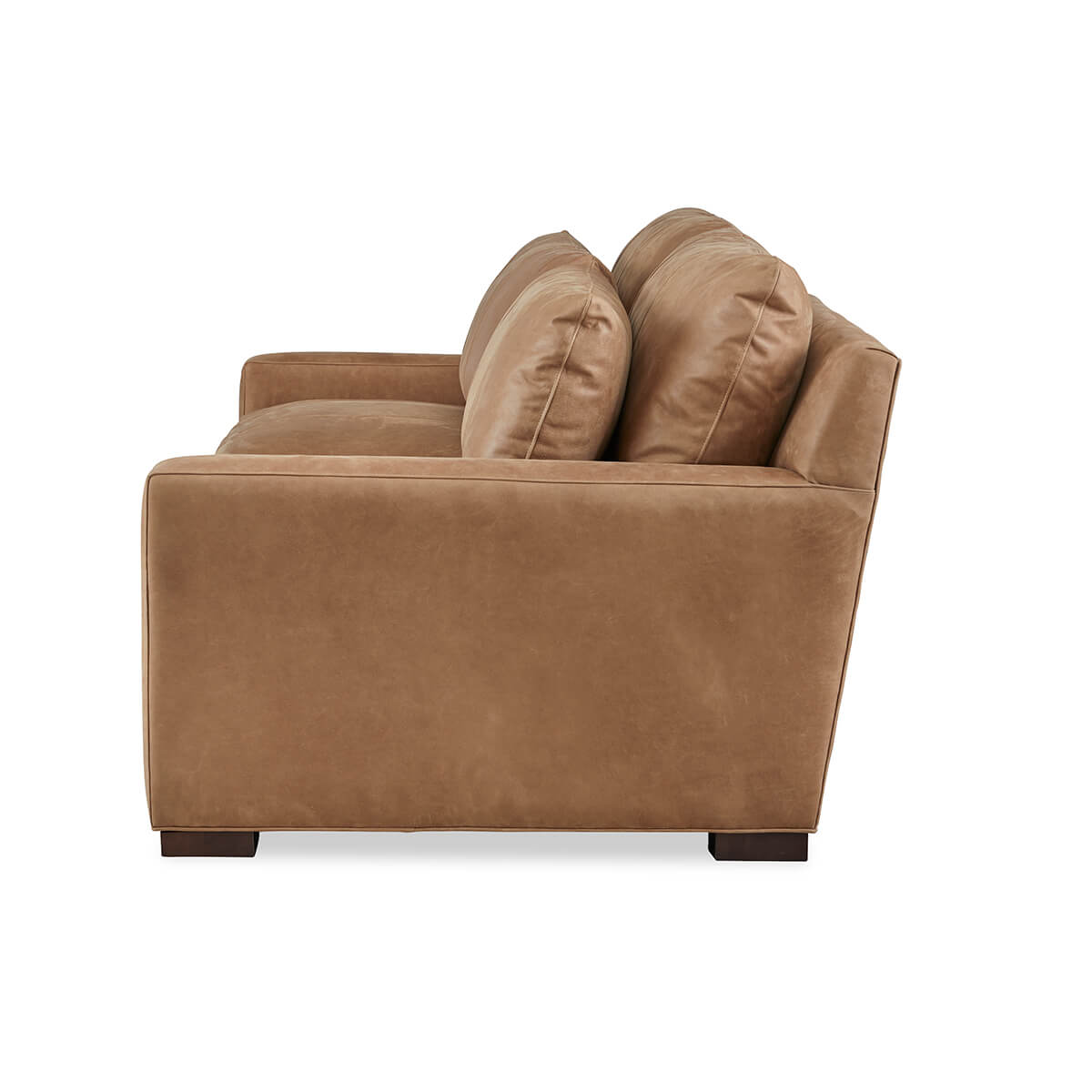 Side profile of tan leather Nest Deep Custom sofa.