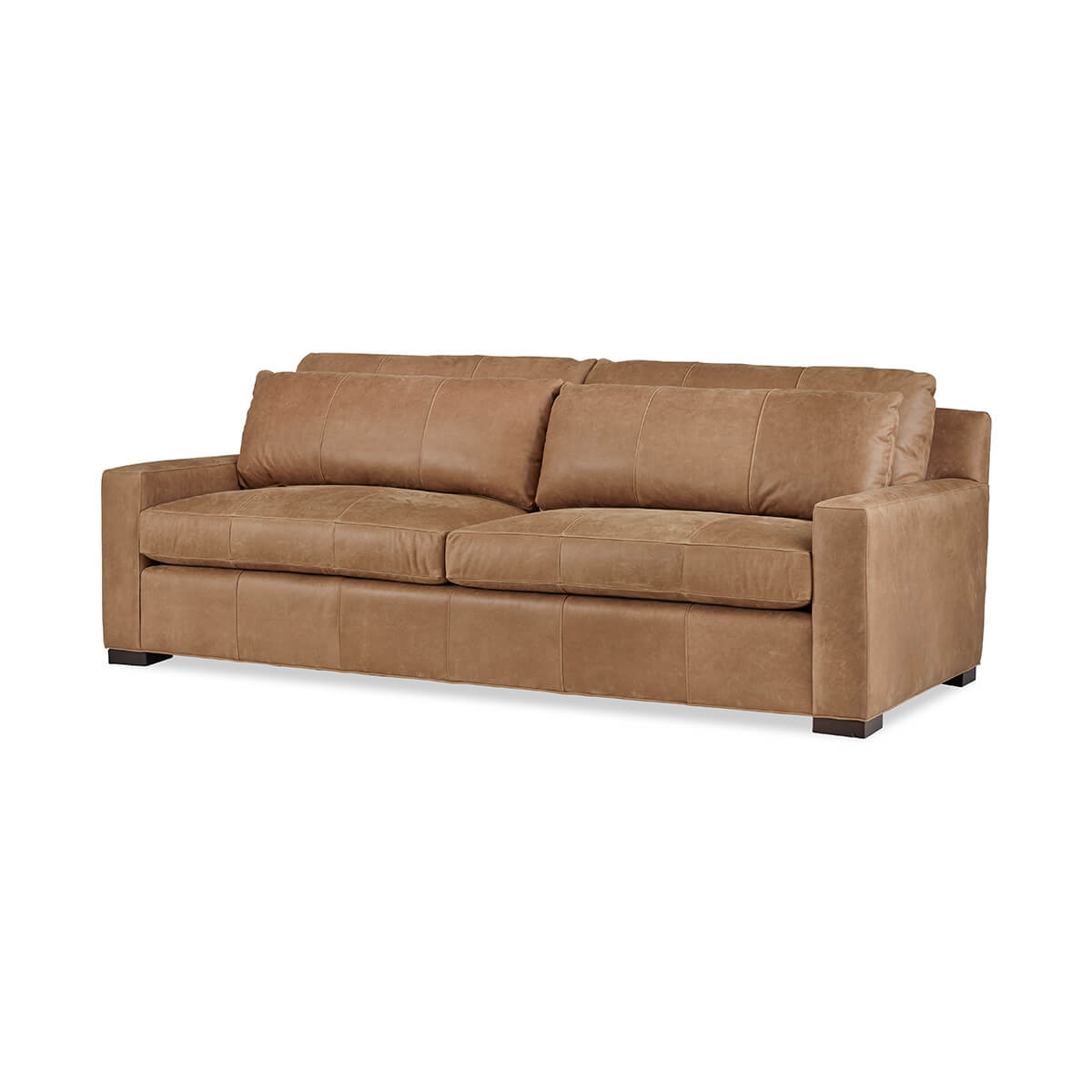 Tan leather sofa on angle, Nest Deep Custom design.
