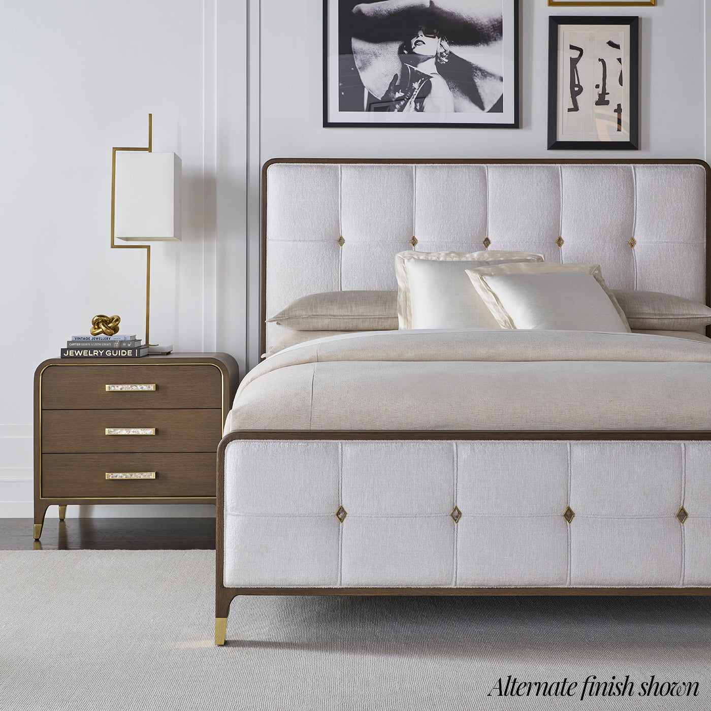 Alternate finish nightstand next to bed with white tufted headboard.