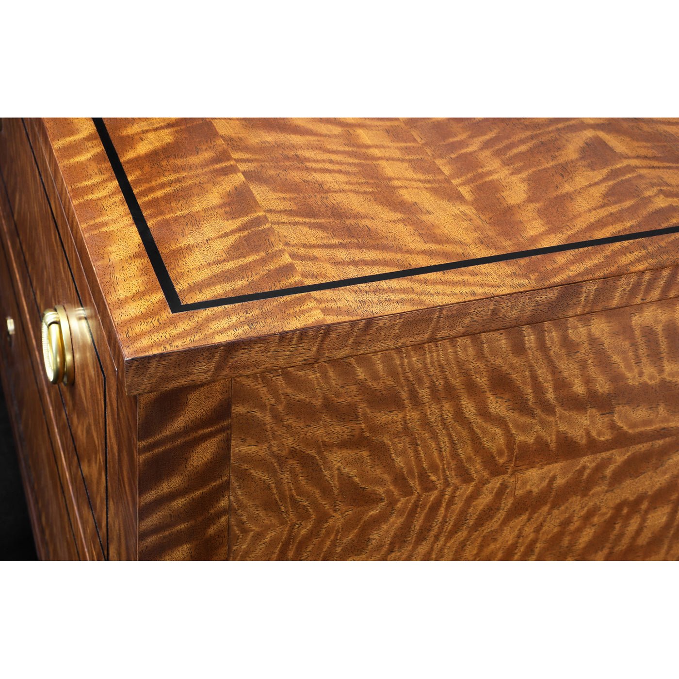 Wood grain detail on commode chest top.