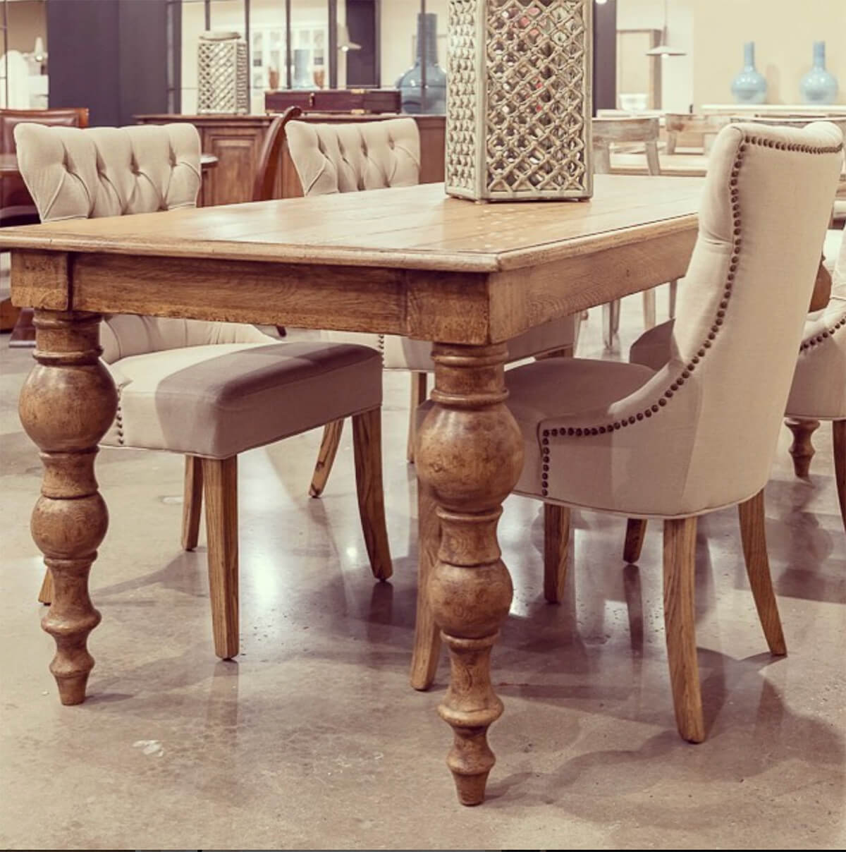 Oak farmhouse dining table with chairs in dining room.