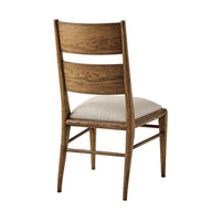 Back view of oak dining chair with cushion.