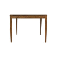 Oak dining table from side view, highlighting legs.