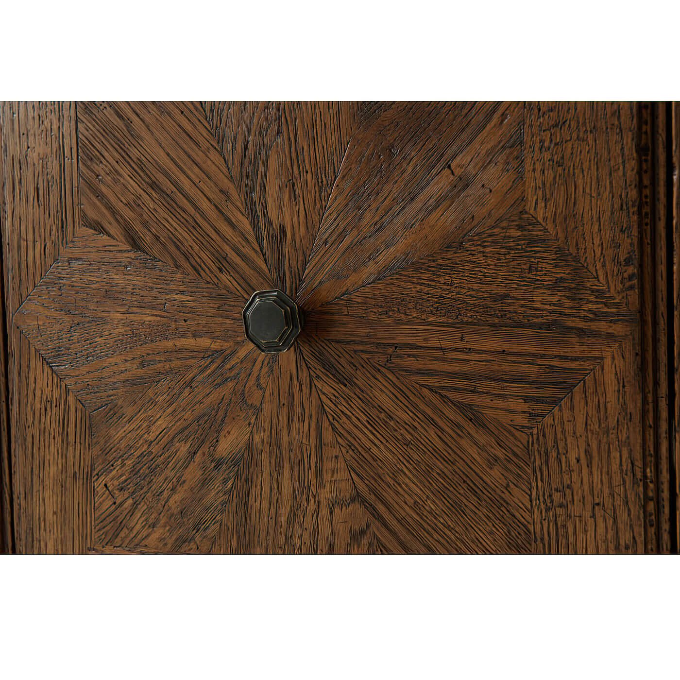 Close-up of oak cabinet door with knob detail.