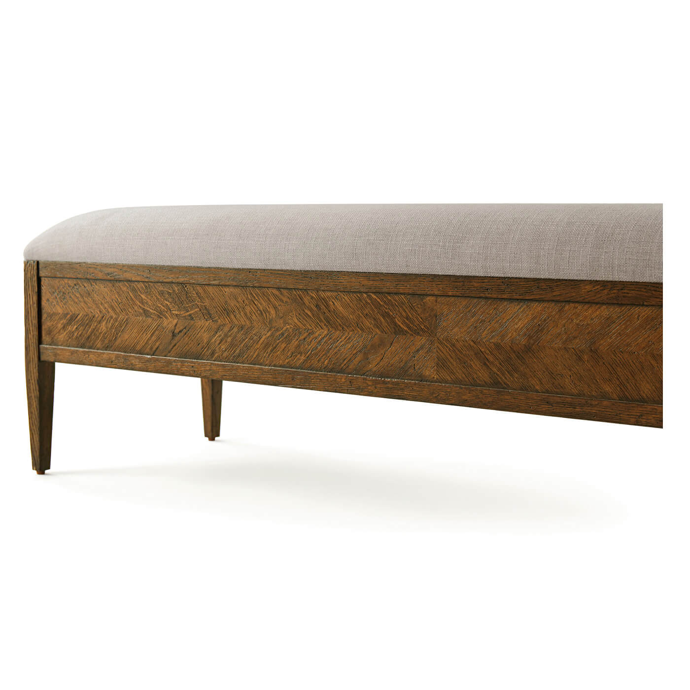 Close-up of upholstered bench, side view, oak parquetry.