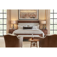 Upholstered bench in bedroom setting, under a large window.