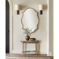 Decorative oak Venetian mirror above rustic table setting.