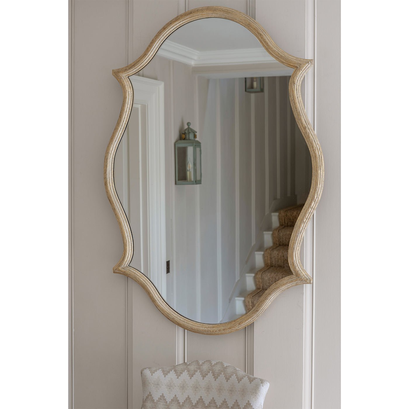 Oak Venetian mirror hanging in a stylish hallway.