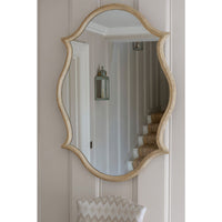 Oak Venetian mirror hanging in a stylish hallway.
