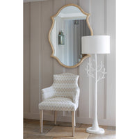 Oak Venetian mirror in room with chair and lamp.